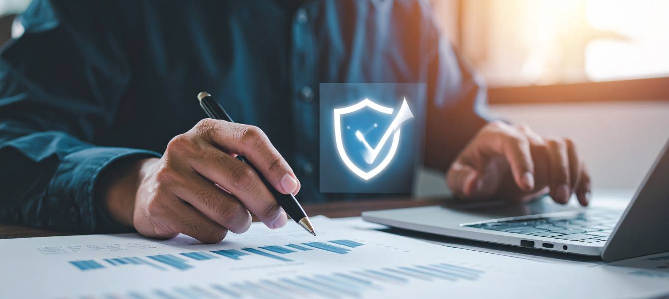 Hände eines Mannes der am Laptop sitzt und Daten überprüft